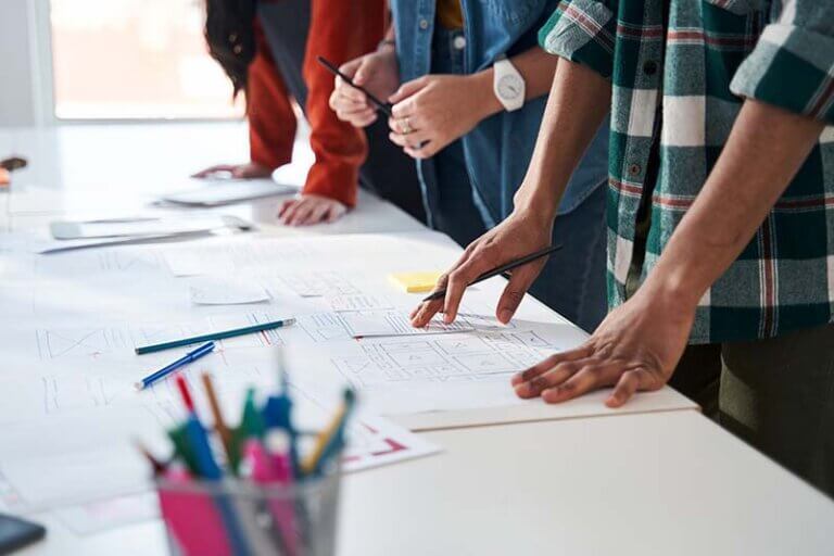 A team of people meeting about planning a website redesign.