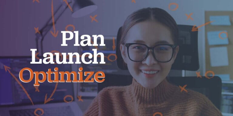 A web designer sitting at her desk with a complicated plan behind her.