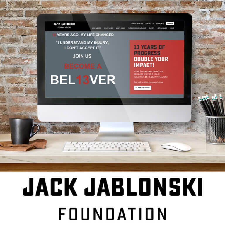JJF's new website on monitor screen with logo underneath.