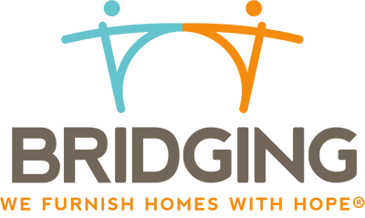 "Bridging logo featuring two stylized human figures forming a bridge shape—one in light blue, the other in orange—above the word 'BRIDGING' in bold gray letters. Below, the tagline reads 'We furnish homes with hope®' in orange capital letters."