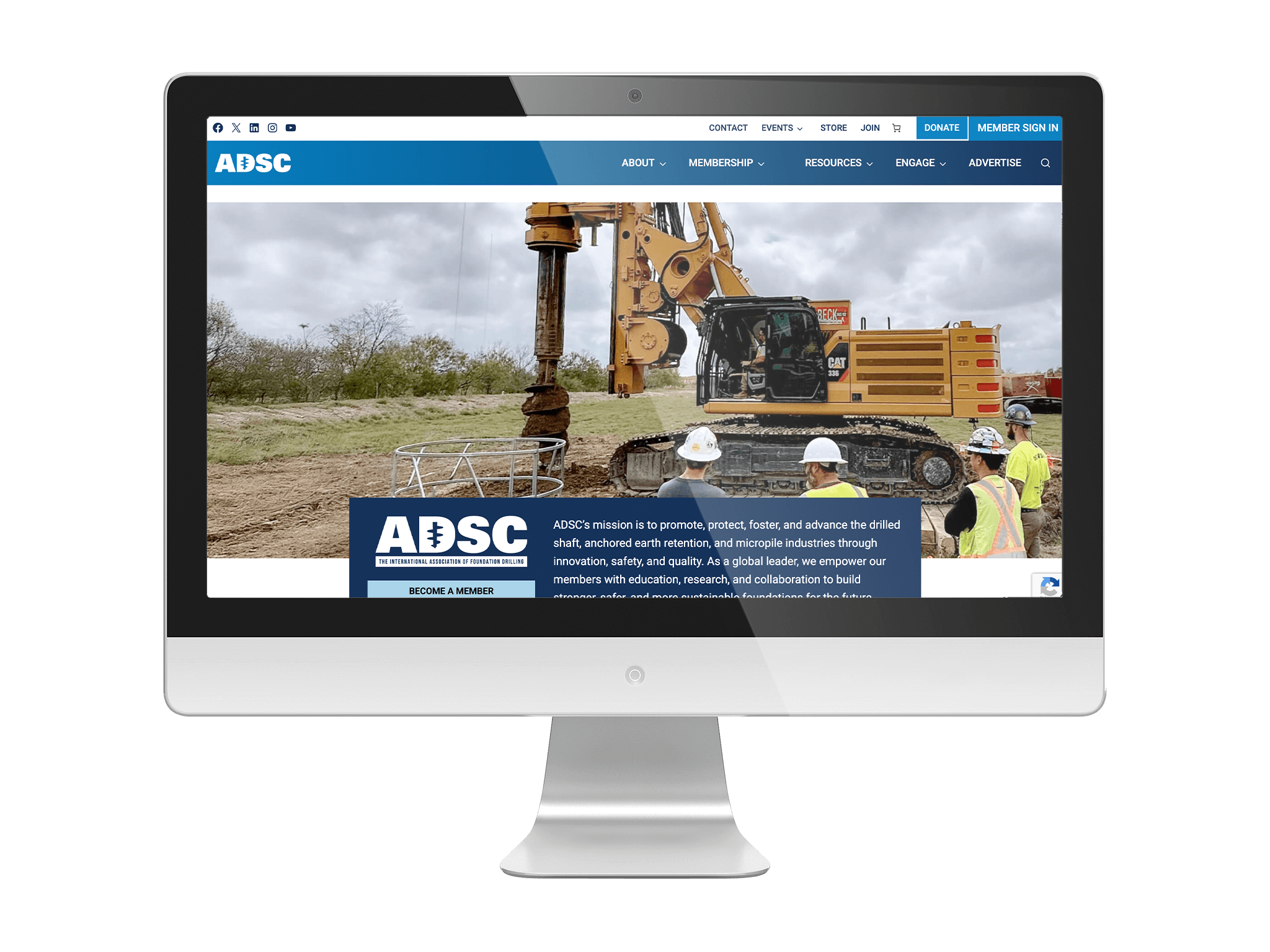 Desktop computer mockup displaying the redesigned ADSC website by ArcStone, featuring a drilling rig on a construction site with workers in safety gear visible in the hero banner.